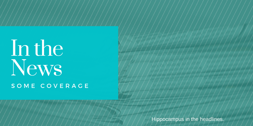 banner that says news coverage and has stack of newspapers in back