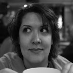 kelly evans looking to left with cup of tea