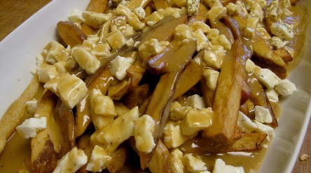 plate of poutine, canadian fries with gravy and cheese curds