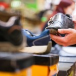 Customer Holding Formal Shoe at Supermarket
