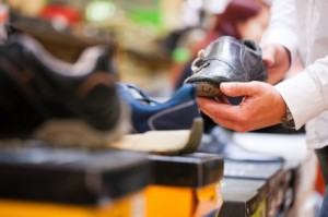 Customer Holding Formal Shoe at Supermarket