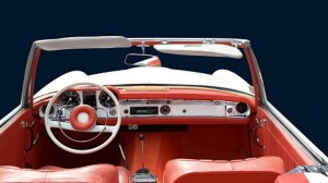 interior of an old convertible looking from backseat to steering wheel