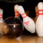 bowling ball knocking down four pins
