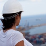 woman in white hard hat looking at harbor