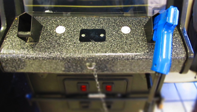 blue gun in arcade game holster