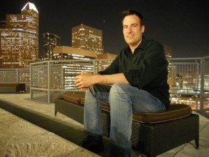 erik dane rooftop with cityscape behind