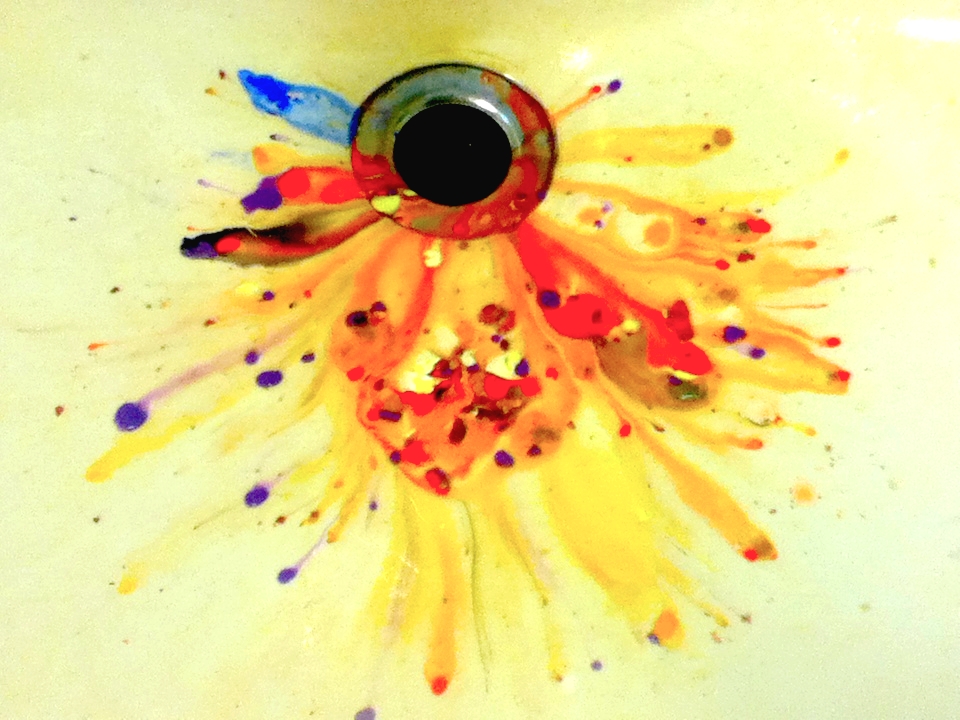 sink drain with splatters of paint