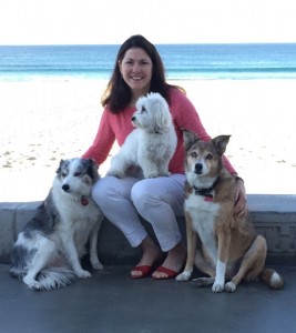 author with her three dogs by beach