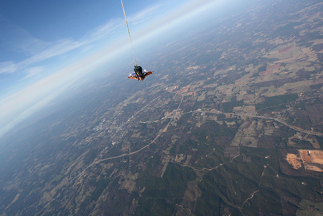 skydiving over farm fields 