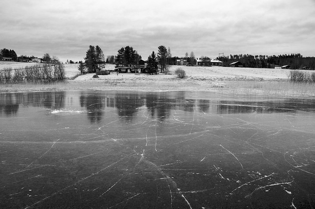 frozen lake with house in back