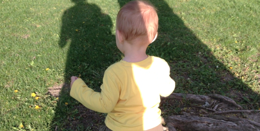 baby in grass with shadow