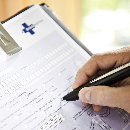 close-up of someone filling out doctor health form