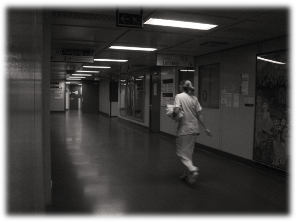 nurse with pony tail walking down hall, fuzzy
