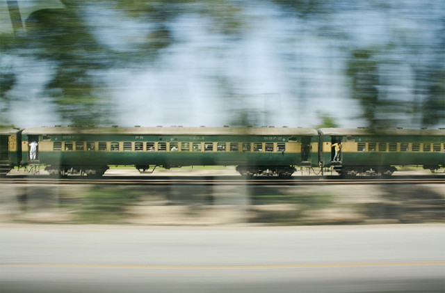 fast-moving train as depicted by blur - you can see people on steps by doors