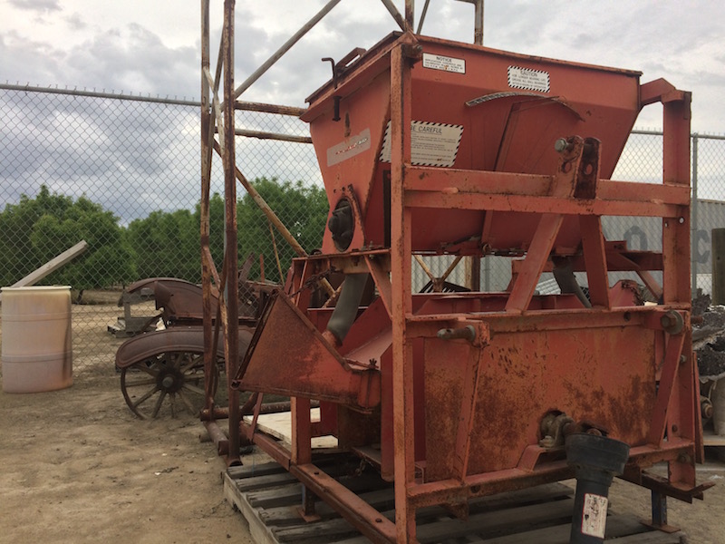 Walker Sulfur Machine with corn stalks behind