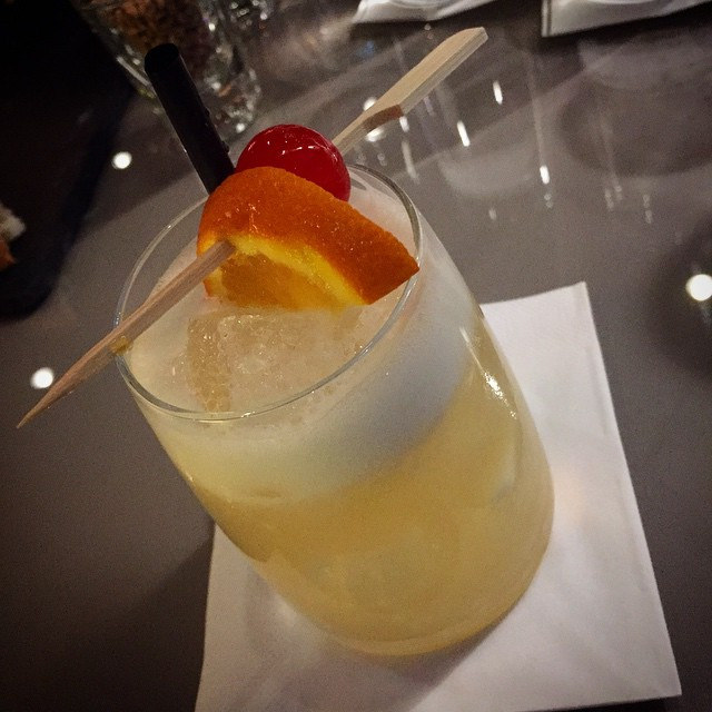 whiskey and oj with orange slice and cherry