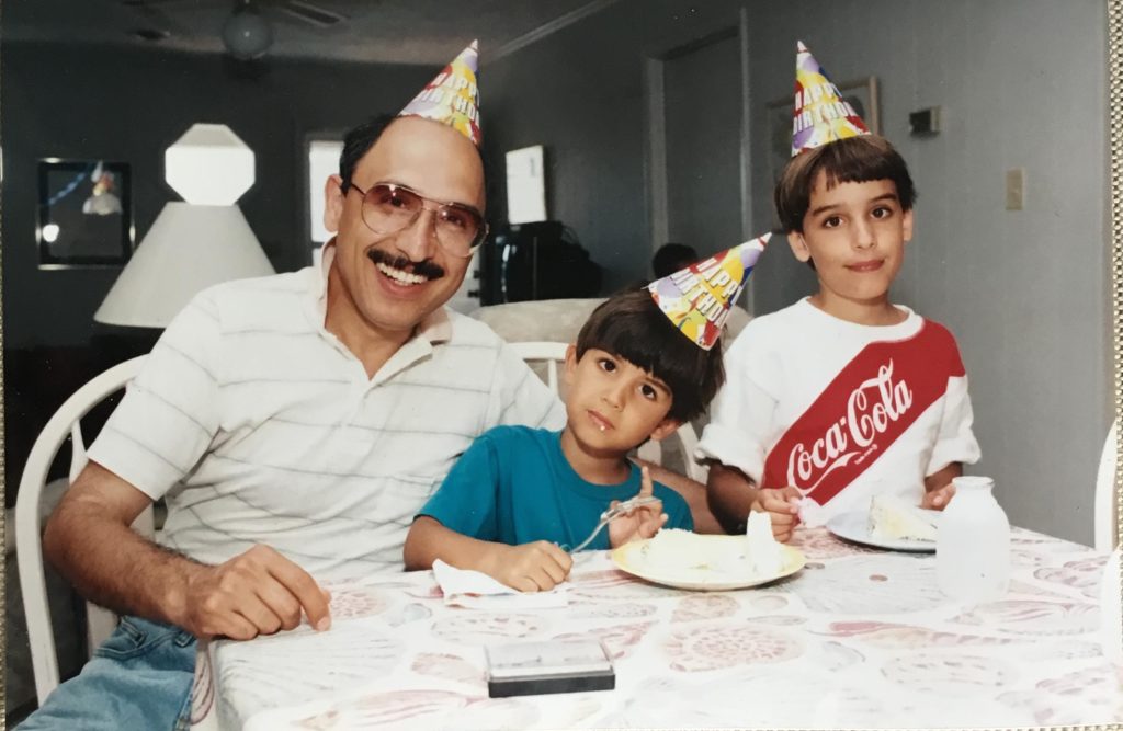 the author and his dad and two brothers with birthday hats