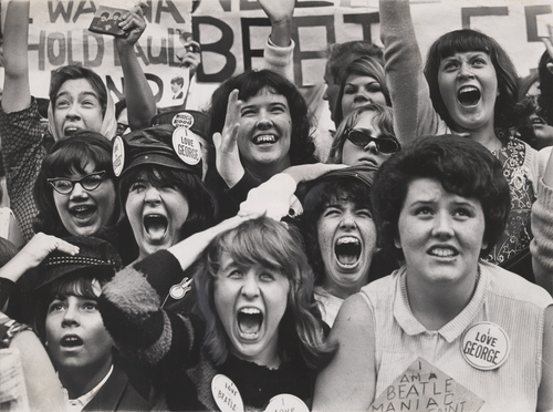 Beatles fans, crowd of women, 60s hair, some wearing I Love George pins