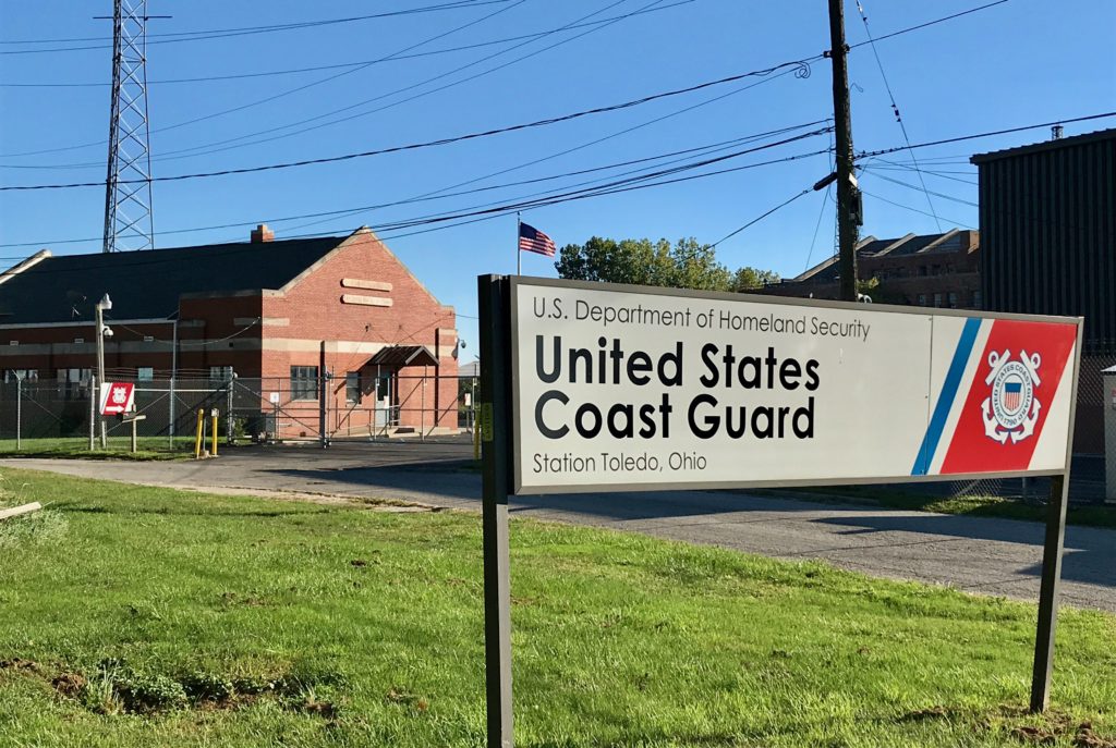 toldeo ohio coast guard station sign with brick builidng in back