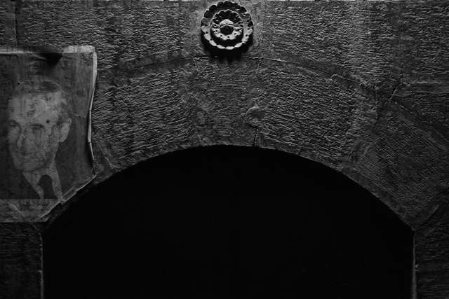 image of dark tunnel with black and white photo of man, Assad Jr