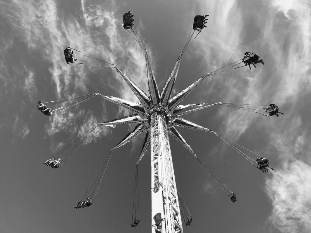 swings ride spinning around high up on boardwalk