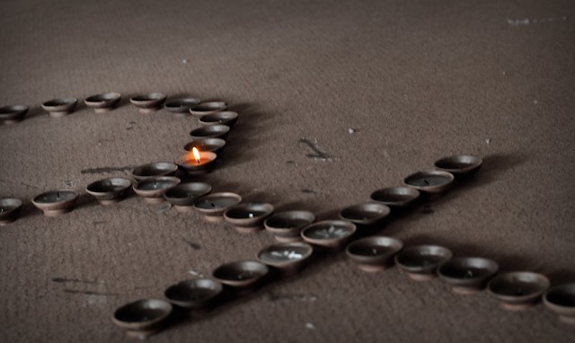 female sign (cross with circle on top) made out of tea light candles