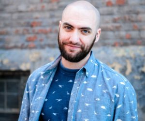 sam chiarelli wearing shirt with tiny dinos all over it