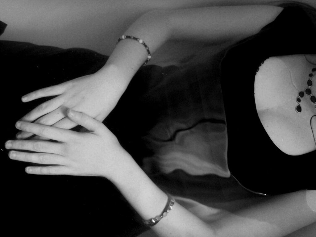 close up of woman's hands on her abdomen; face out of frame