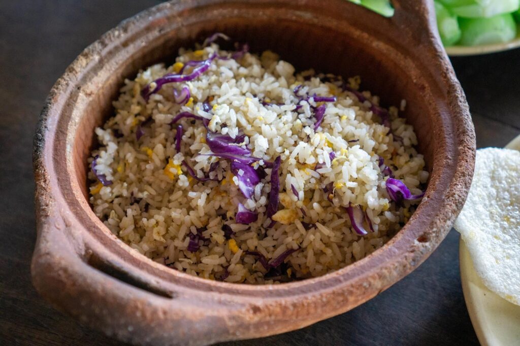 rice, corn and onion in a ceramic bowl