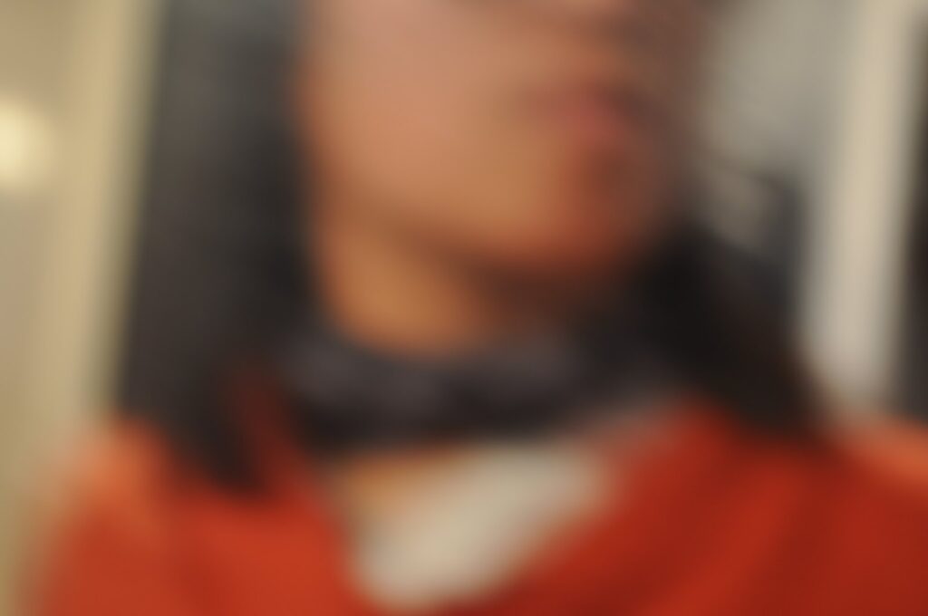 blurry image of female presenting person