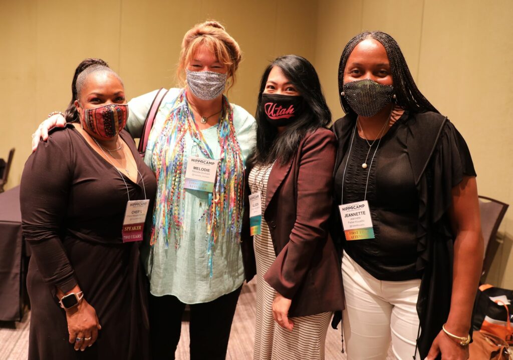 four women -- new friends -- posed at HippoCamp wearing masks