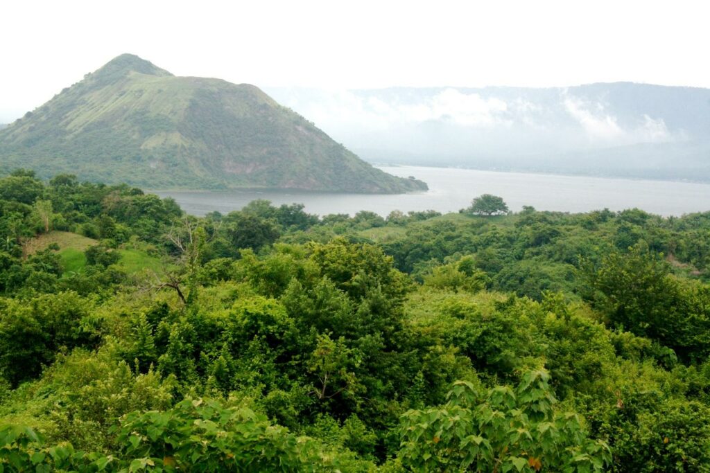 misty green mountain scene with cloud cover