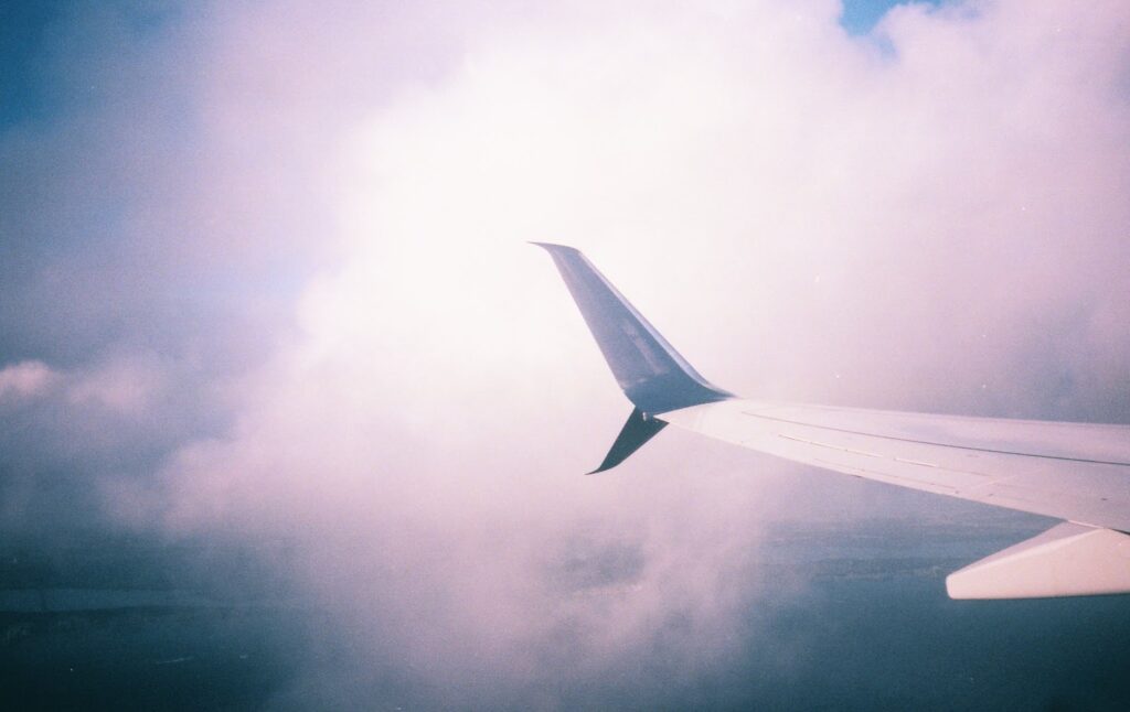 airplane wing in pink clouds