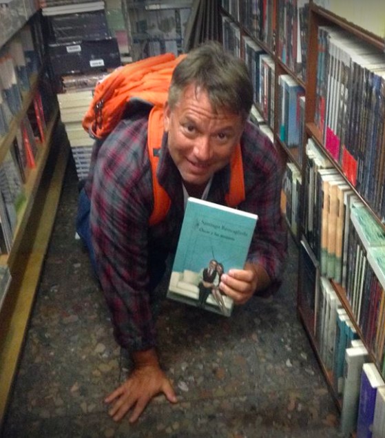 nicolas poynter holding up book in library