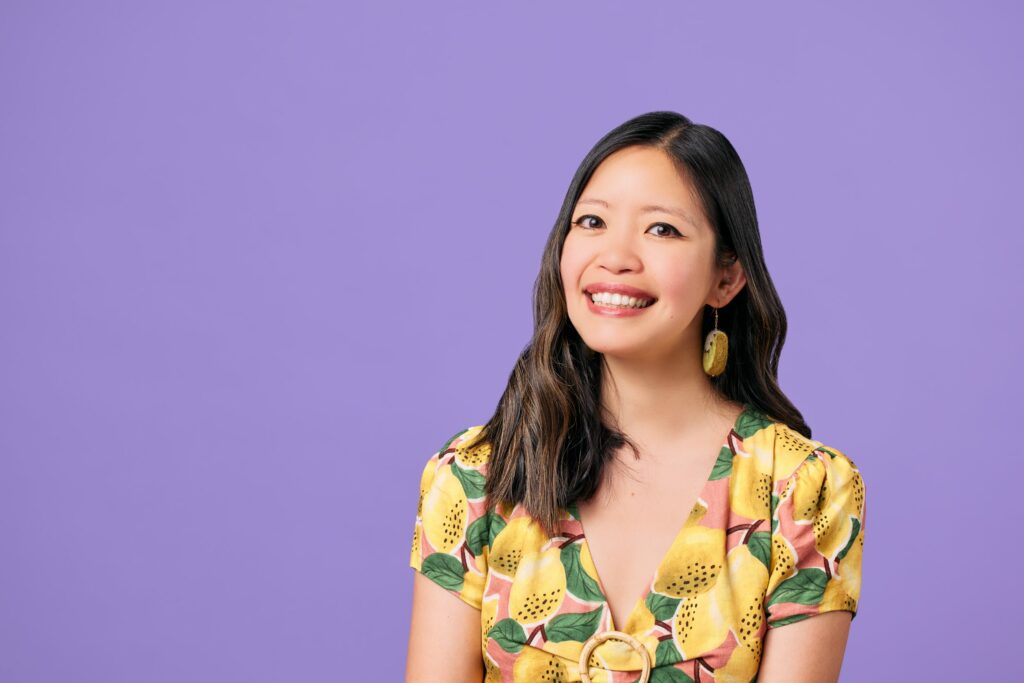 Jane Wong headshot on lilac colored background.