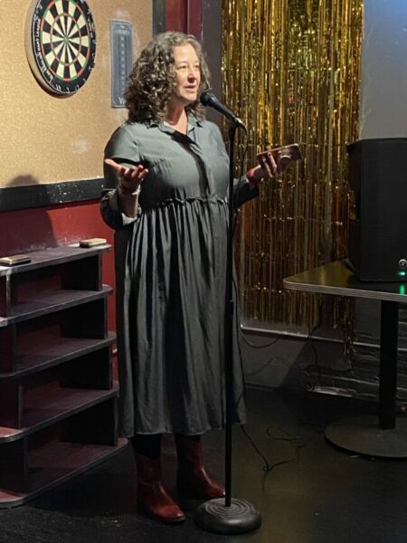 janna maron at mic at reading event 