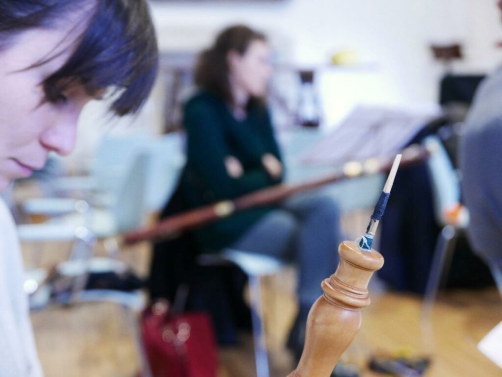A child looking at a woodwind instrument