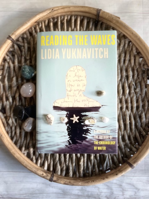 cover of Reading the Waves: A Memoir by Lidia Yuknavitch - image of papercut out of human in a body of water