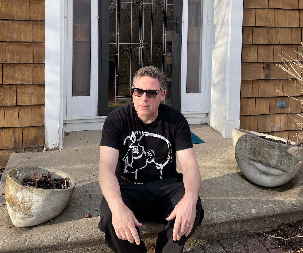 Chuck Rybak sitting on stoop