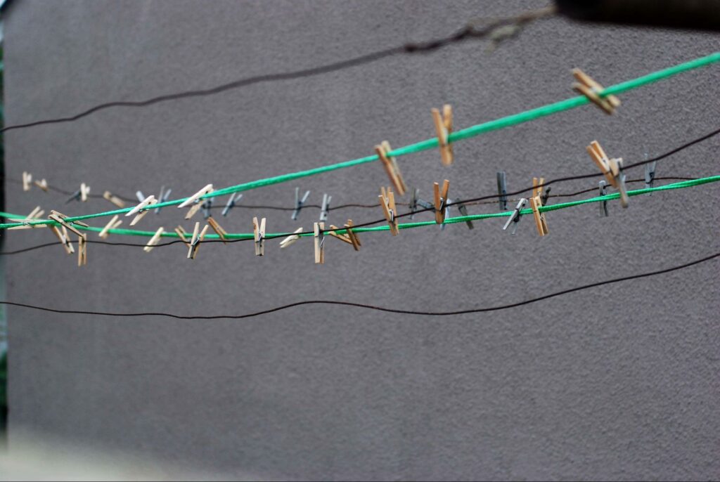 wire outdoor clothesline with dozens of colorful clothespins