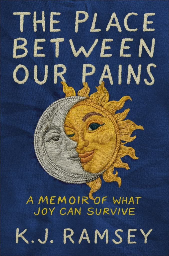 cover of The Place Between Our Pains: A Memoir of What Joy Can Survive by K.J. Ramsey, with the title and a sun and moon embroidered