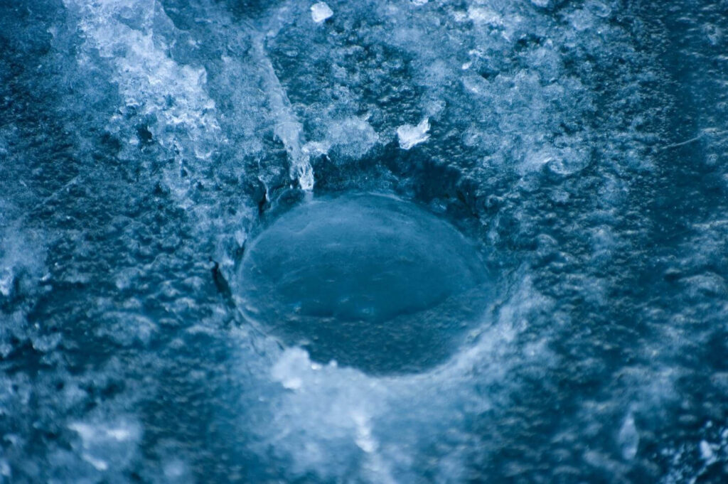 a hole in the ice that looks like a hole in the ground