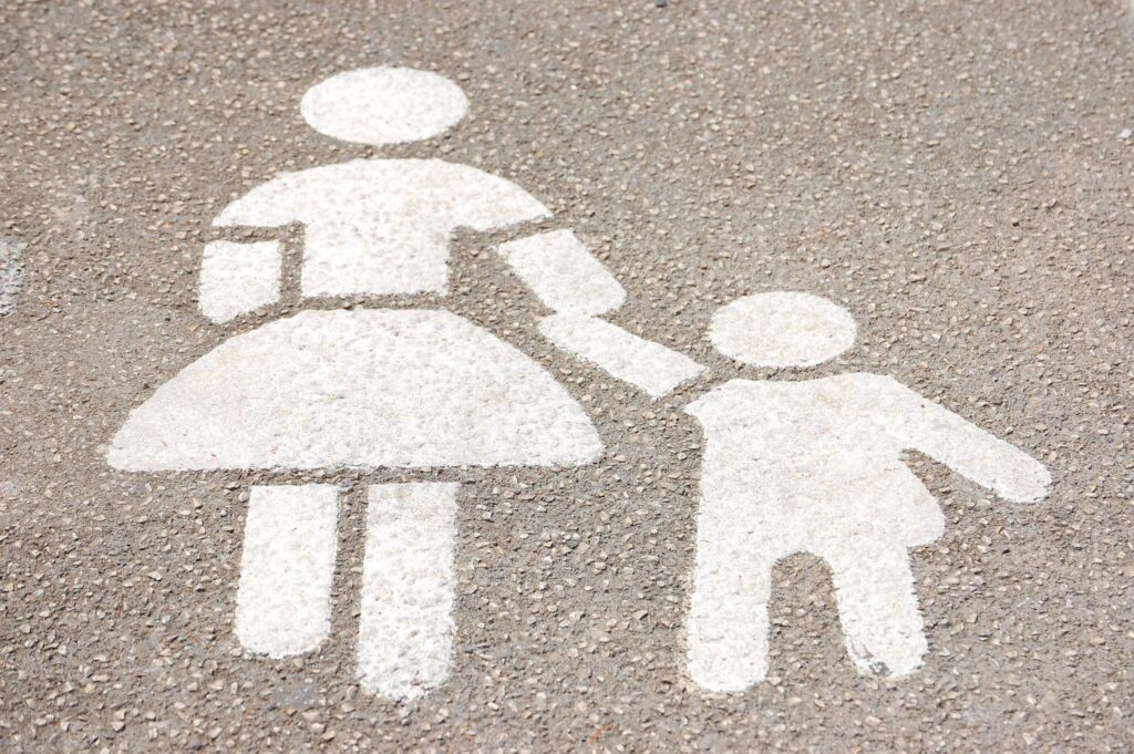 parking lot stencil of woman walking with child