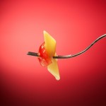 penne pasta on a fork with a little sauce