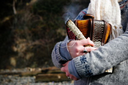 arms of girl in sweater wrapped around an urn