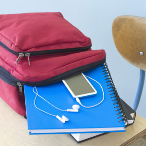 Backpack with ipod and notebook falling out on desk