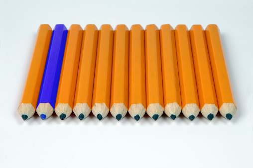 row of yellow pencils with one blue pne