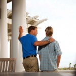 father and teenage son looking out