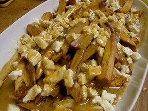plate of poutine, canadian fries with gravy and cheese curds