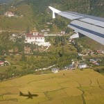plane over buthan with village below